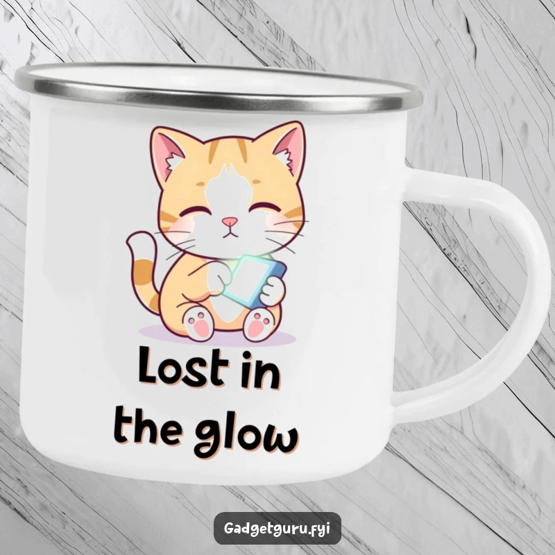 Funny camping mug showing a curious cat pawing at a small, glowing screen, ready for adventure.