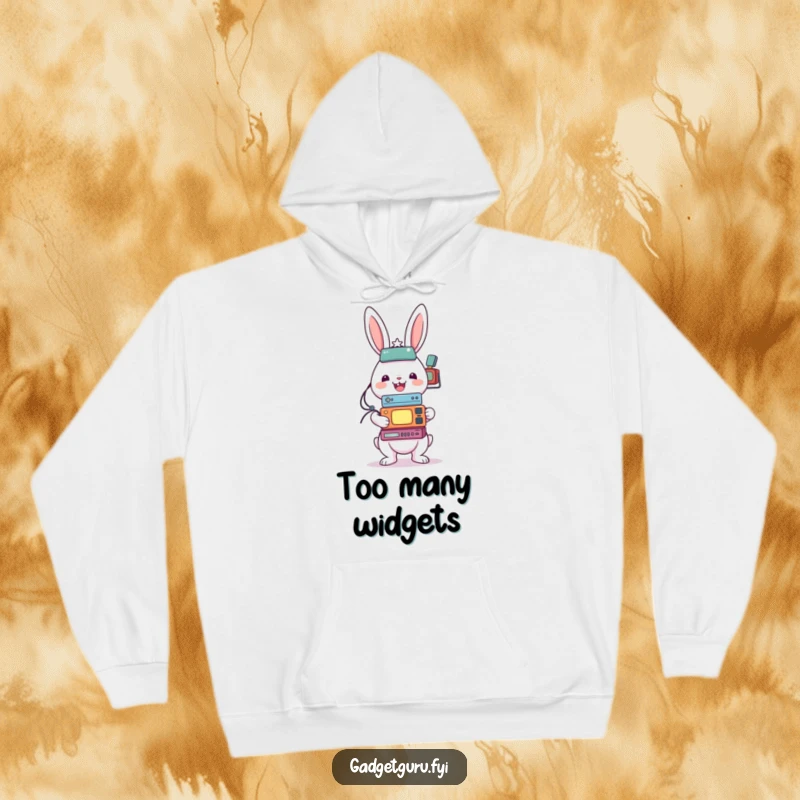 Funny hoodie displaying a cheerful rabbit character in the process of balancing a precarious stack of various small tech gadgets.